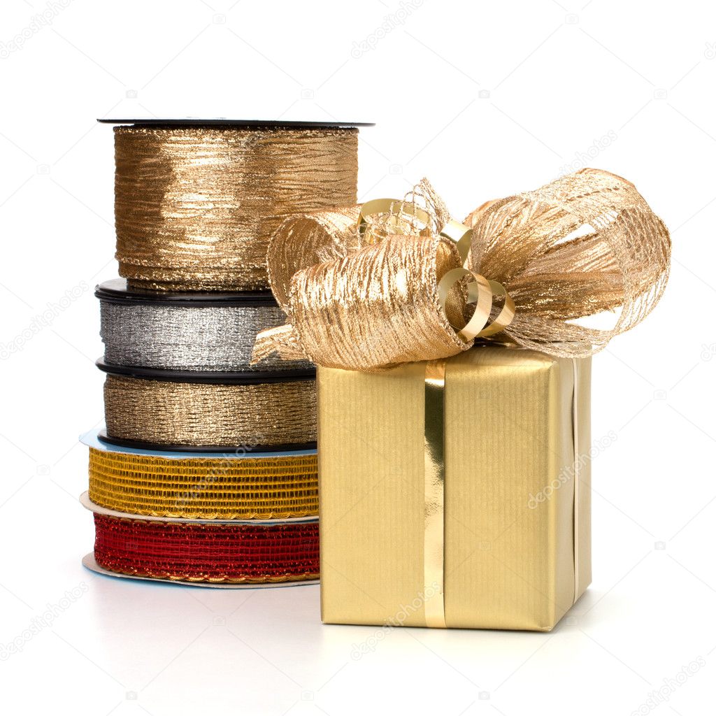 Festive gift box and wrapping ribbons isolated on white backgrou