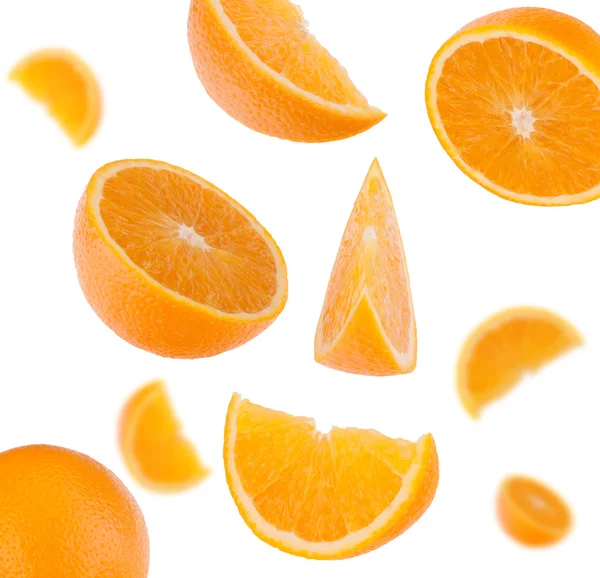 Flying sliced orange fruit segments — Stock Photo, Image