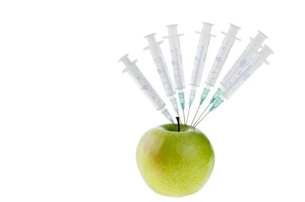 Syringes objects and green apple over white — Stock Photo, Image