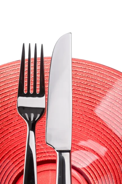 Kırmızı plaka üzerinde bıçak ve çatal — Stok fotoğraf