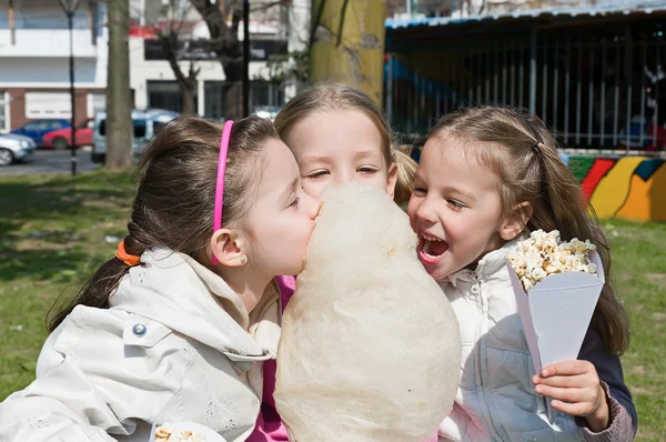 Little girls eating candy-floss — Stock Photo, Image