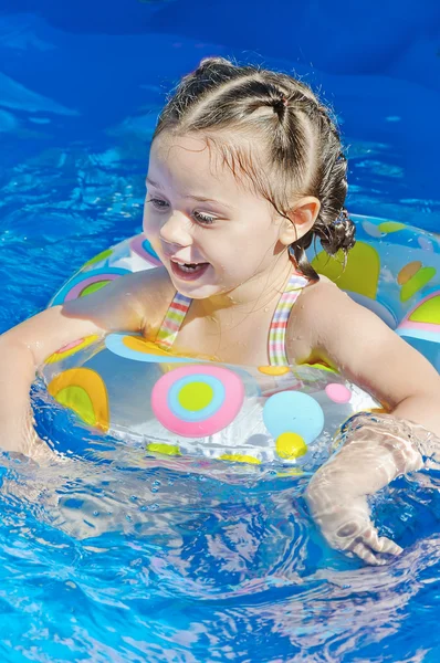 Mała dziewczynka pływa w basenie — Zdjęcie stockowe