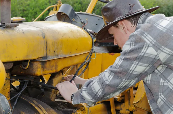 Portrait of a farmer on the tractor fixing Royalty Free Stock Images