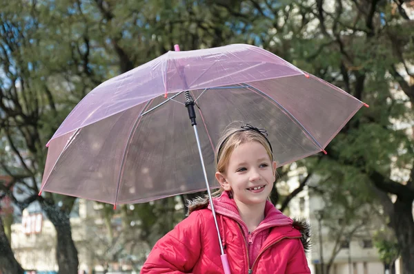 Little girl with umbrella in park — Stock Photo, Image