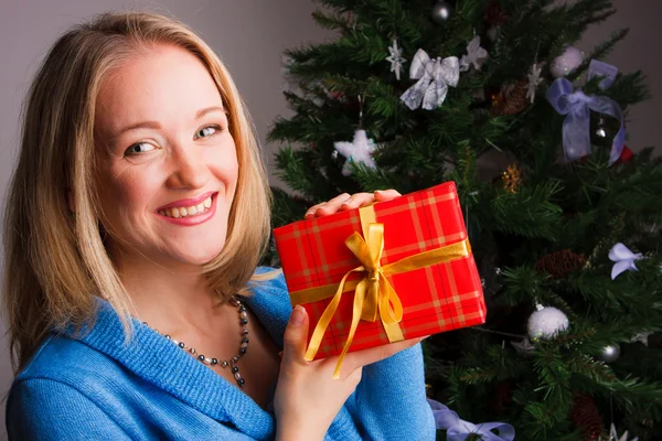 漂亮的女人和一份圣诞礼物 — 图库照片