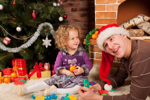 Petite fille jouer avec papa près de l'arbre de Noël — Photo