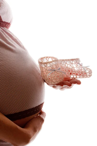 Gravid kvinna med baby stövletter — Stockfoto
