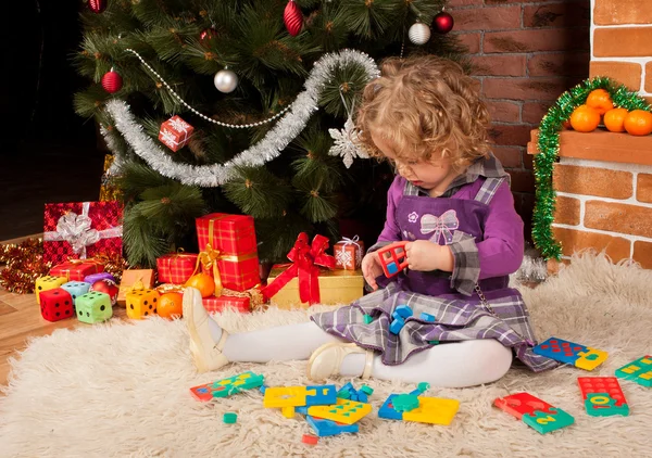 Menina jogar perto da árvore de Natal — Fotografia de Stock