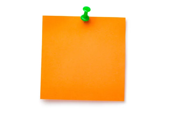 Adesivo laranja em thumbtack verde — Fotografia de Stock