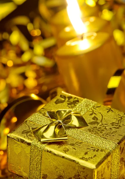 Gold christmas candles and gold gift boxes — Stock Photo, Image