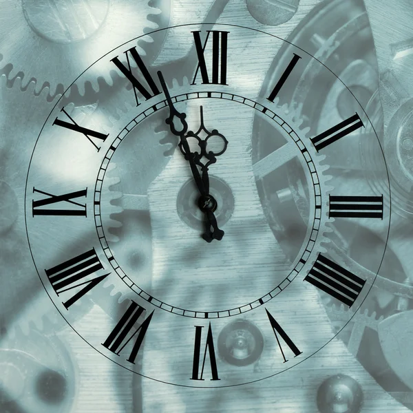 Old hours with figured arrows on mechanism blur background — Stock Photo, Image