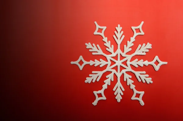 The big snowflake on a red background — Stock Photo, Image