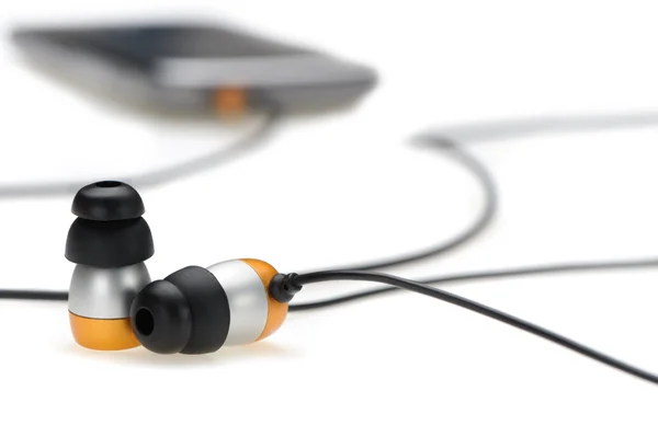 In ear hörlurar med bärbara ljudspelare — Stockfoto