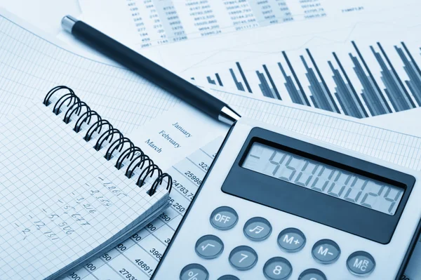La calculadora y el informe financiero tonificado azul — Foto de Stock