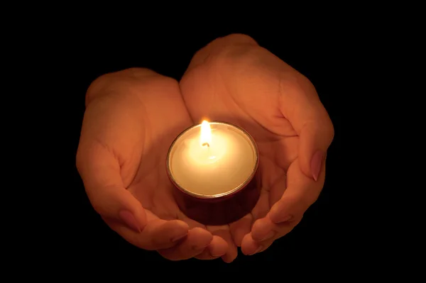 Burning candle in female hands — Stock Photo, Image