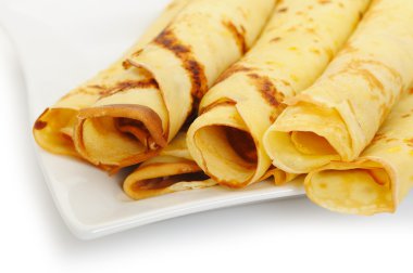 Crepe roll up a tubule on a plate clipart