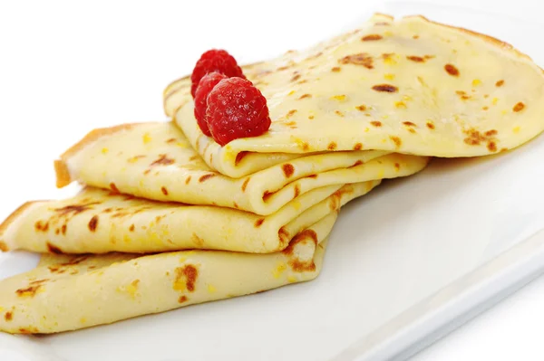 Crepe on a plate with a raspberry — Stock Photo, Image