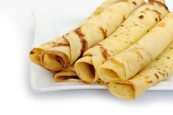 Crepe roll up a tubule on a plate — Stock Photo, Image