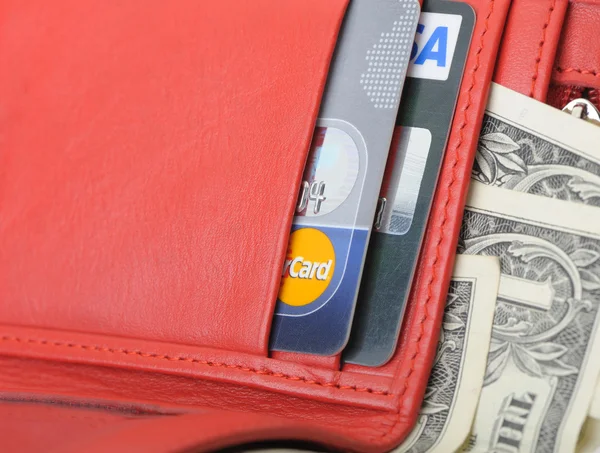 Stock image Red leather wallet with dollars and credit card