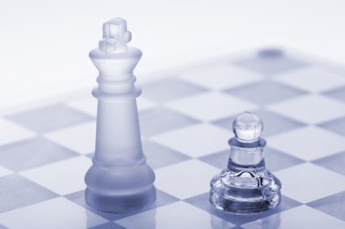 Glass chess. A pawn and a king clipart
