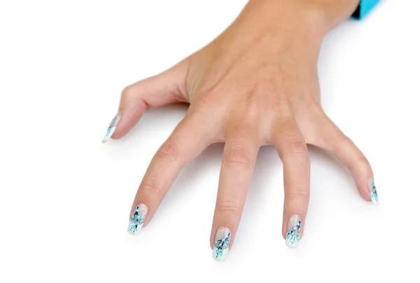 Vrouwelijke hand met manicure close-up. tekening van een bijkantoor met blu — Stockfoto