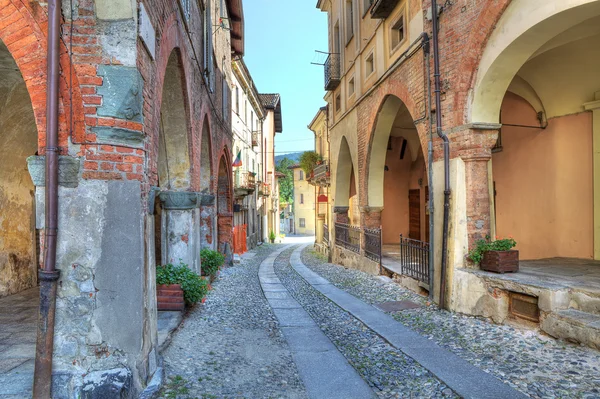 Antigua calle estrecha entre casas antiguas en Avigliana, Italia . — Foto de Stock