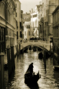 Gondola silhouette on venetian canal. clipart