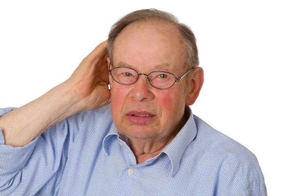 Mannelijke senior met hand op oor — Stockfoto