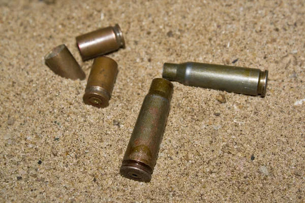Empty cartridges on sand — Stock Photo, Image