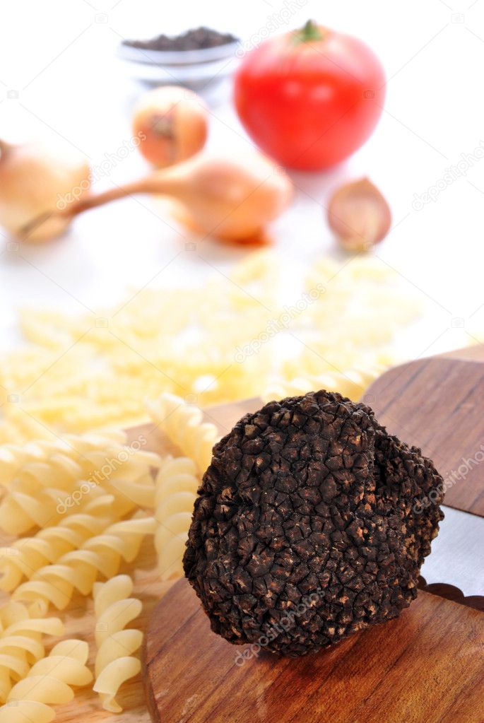 Fresh summer truffle is placed on a truffle slicer