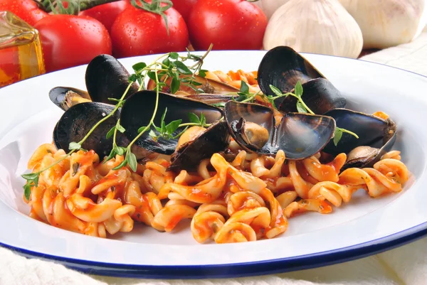 Homemade pasta salad on a plate with cooked mussels and fresh to — Stock Photo, Image
