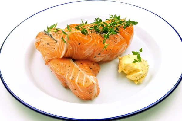 Salmon steak with herb butter and thyme on a plate — Stock Photo, Image