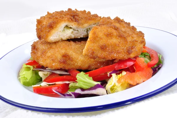 Garlic chicken kiev with mixed leaf salad ready to eat — Stock Photo, Image