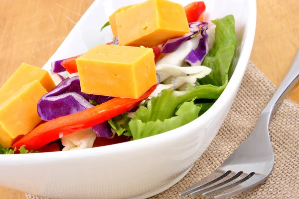 Seasonal salad with mature cheese ready to eat and a fork — Stock Fotó