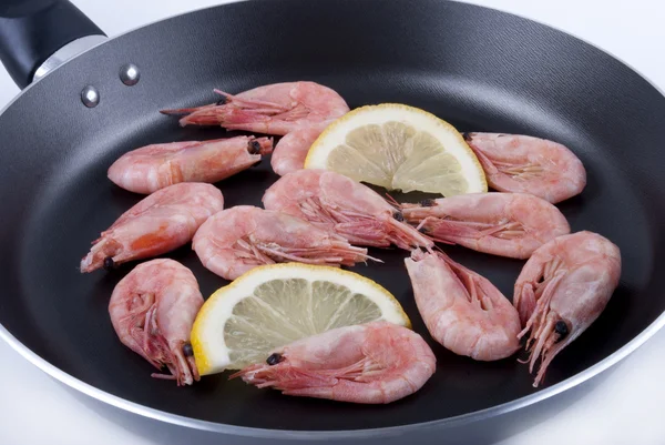 Shrimps with a lemon slice in a pan — Stock Photo, Image
