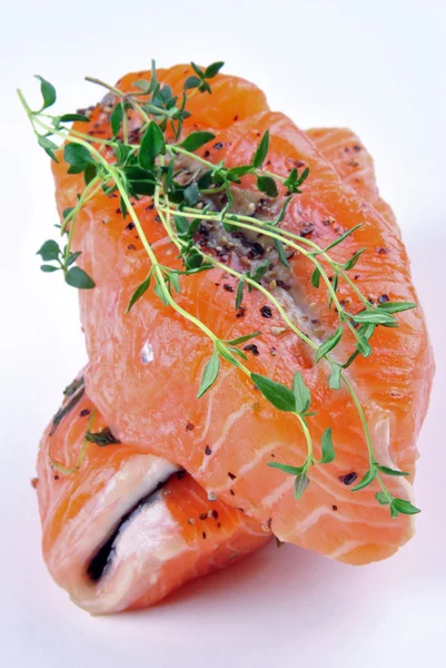 Salmon steak with thyme on a white background — Stock Photo, Image