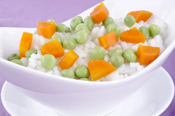 Risotto rice with organic carrots and pea — Stock Photo, Image