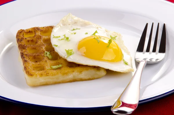 Potato waffle with fried egg on a plate — Stock Photo, Image