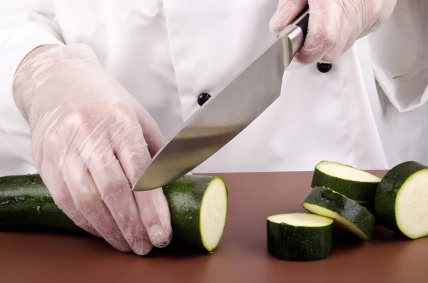 Köchin schneidet Zucchini in dicke Scheiben — Stockfoto