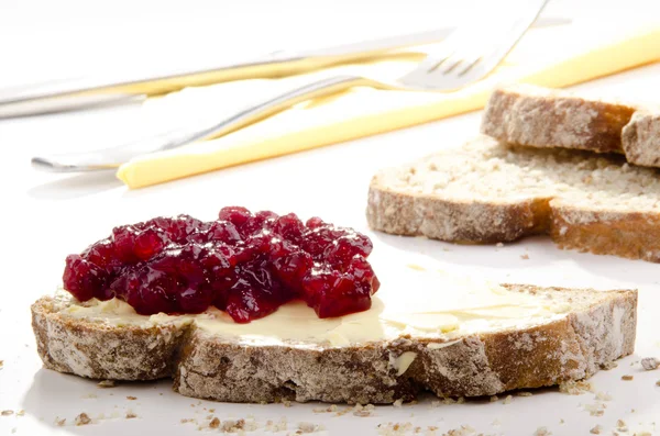 stock image Home made bread spread with cranberry jam