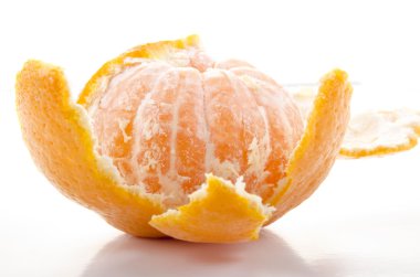 One open organic mandarin on white background