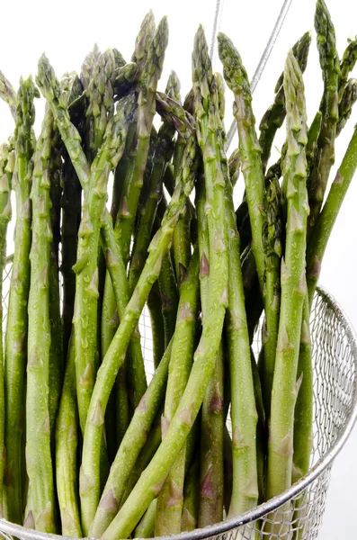 Fresh green asparagus is washed to be prepared as food — Stock Photo, Image