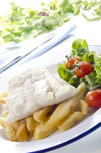 Cod fillet on french fries with salad and tomato — Stock Photo, Image