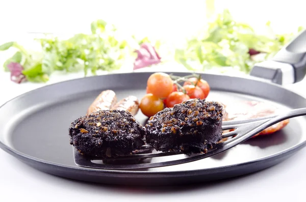 Two slices of black pudding on a spatula — Stock Photo, Image