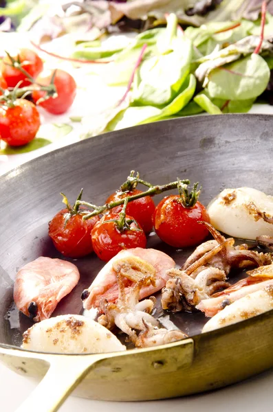 Pan with seafood and grilled tomatoes — Stock Photo, Image