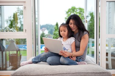 Mother and daughter with laptop clipart