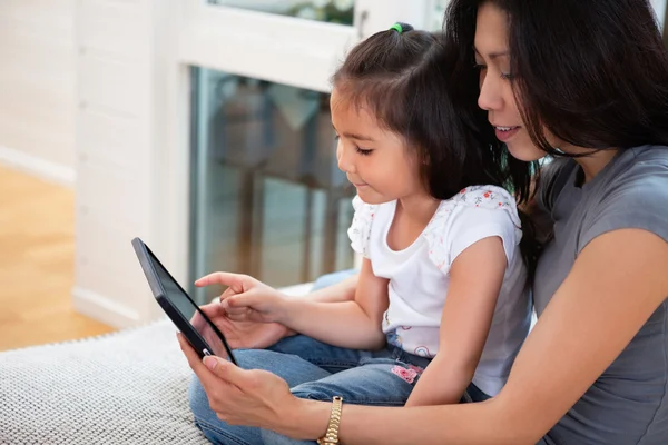 Mother and daughter reading electronic book — Stock Photo, Image