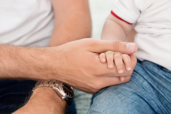 Father holding child's hand — Stock Photo, Image