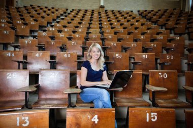 Woman Student in Empty Lecture Hall clipart