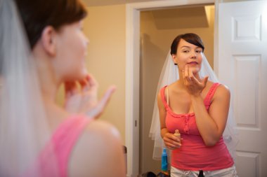 Bride Applying Make up clipart